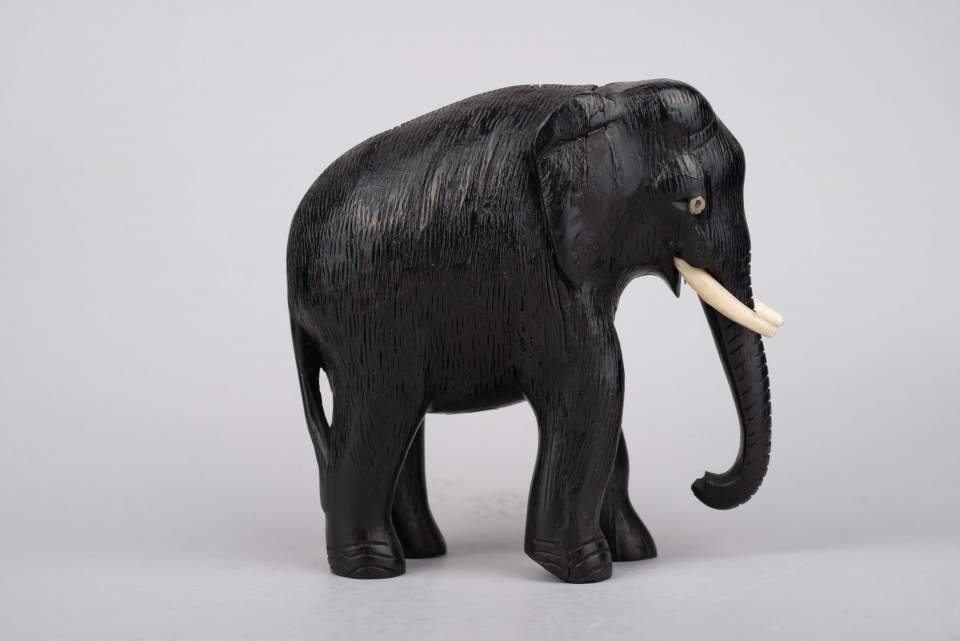 Elefant aus Holz mit zwei Stosszähnen